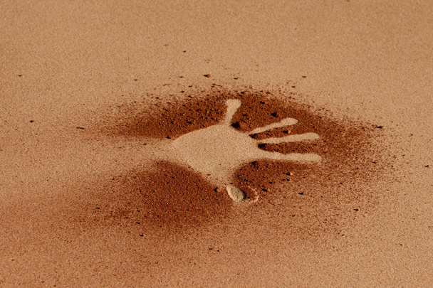 Red soil hand shape on sand like aboriginal art style - Φωτογραφία, εικόνα
