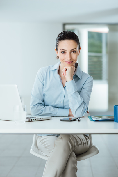 Confident female manager at desk posing - Photo, image