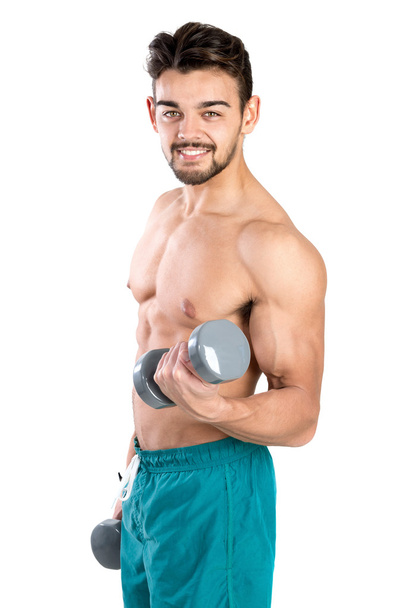 young man exercising with dumbbells - Zdjęcie, obraz