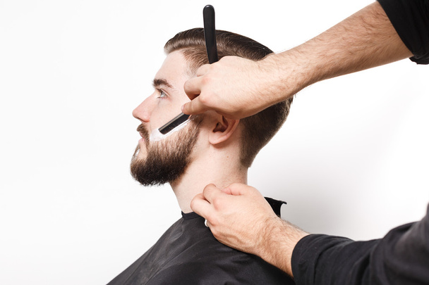 Friseur rasiert jungen Mann - Foto, Bild