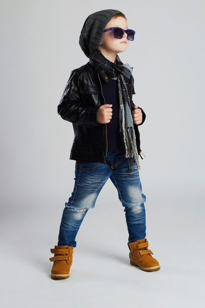 Funny child.fashionable little boy in sunglasses.stylish kid in yellow shoes.winter - Фото, зображення