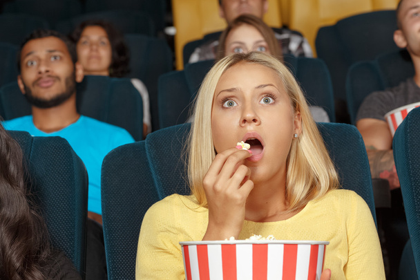 Young girl watching a movie with admiration - Foto, Bild