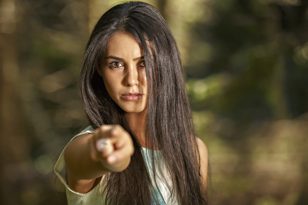 Closeup portrait of young angry woman pointing at someone as if - Photo, Image