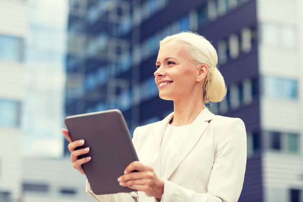 smiling businesswoman with tablet pc outdoors - Photo, Image