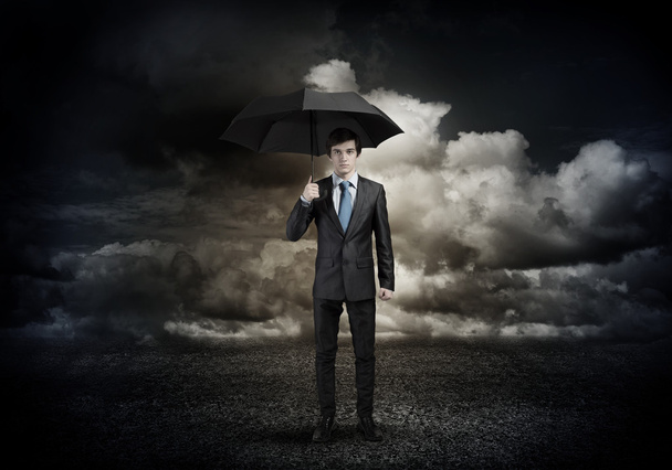 Young Businessman with umbrella - Foto, afbeelding