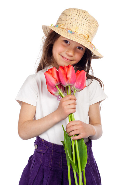 Smiling little girl with red tulips - Photo, image
