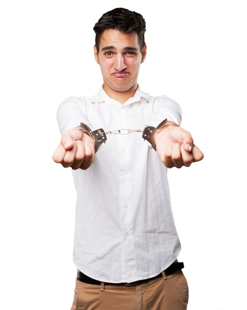 sad young man with handcuffs - 写真・画像