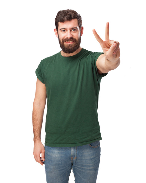 happy young man with victory sign - Фото, зображення