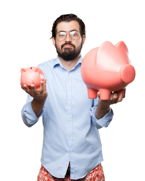 confused young man with piggy bank - Photo, image