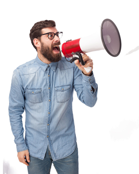 angry young man with megaphone - Фото, изображение