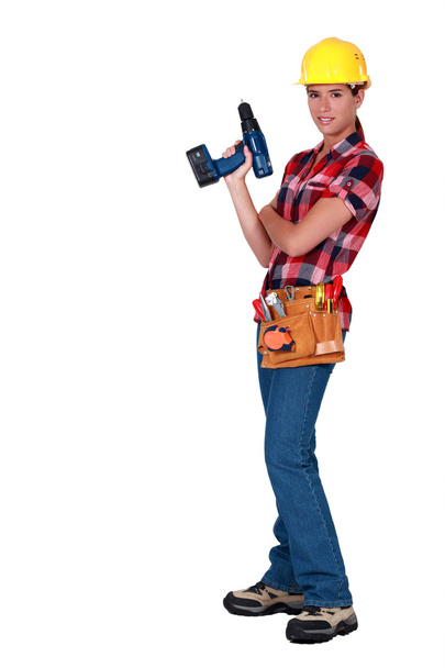 Craftswoman holding a drill - Zdjęcie, obraz