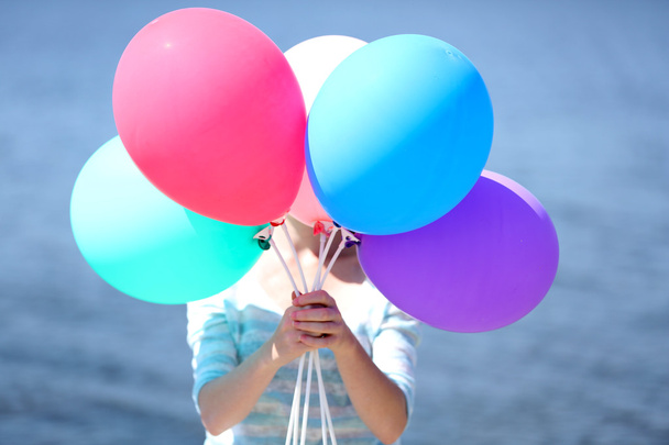 Girl holding balloons near face - Fotografie, Obrázek