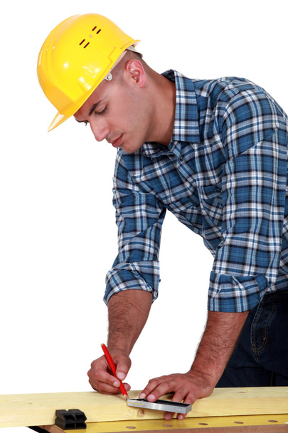 A carpenter taking measures. - Photo, image