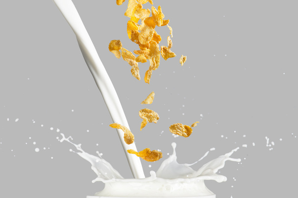 Cornflakes falling into milk splash - Fotoğraf, Görsel