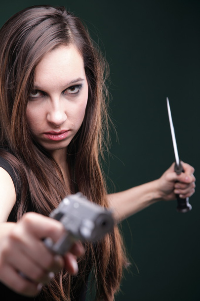 Sexy young woman long hair - gun knife - Zdjęcie, obraz