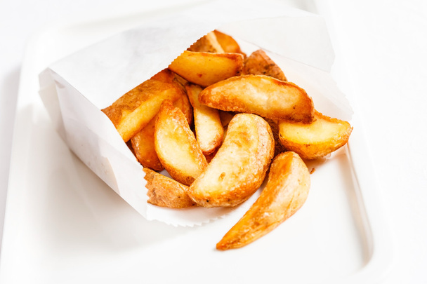 Roasted potatoes on plate - Foto, afbeelding