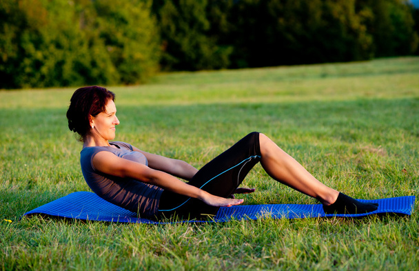 Woman practice yoga outdoor in park - Foto, Imagen
