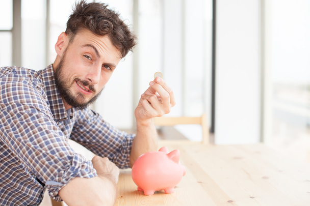 young man with piggy bank - Foto, immagini