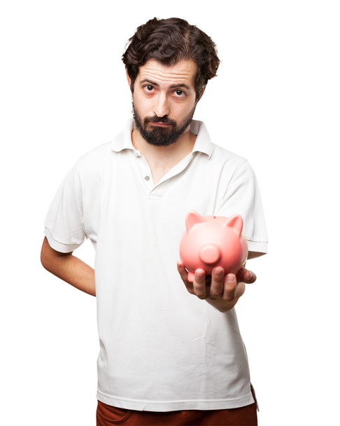 sad young man with piggy bank - Foto, afbeelding