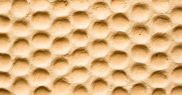 Texture of yellow wall plastered in form of honeycombs - Photo, Image