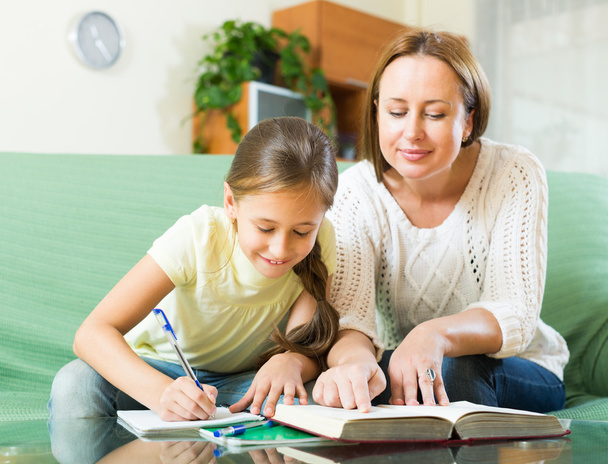 Mother with daughter doing homework - Photo, Image