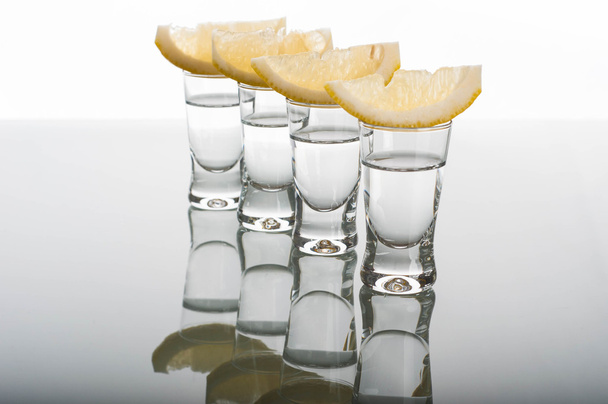 Four shots of vodka with lemon - Photo, Image