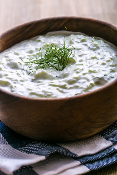 Tzatziki. Greek salad tzatziki  of cucumber, yogurt or cream, olive oil, garlic, dill and spices. Herb decoration of dill. - Fotoğraf, Görsel