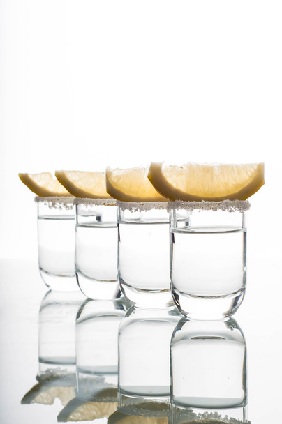 Four shots of vodka with lemon - Fotó, kép