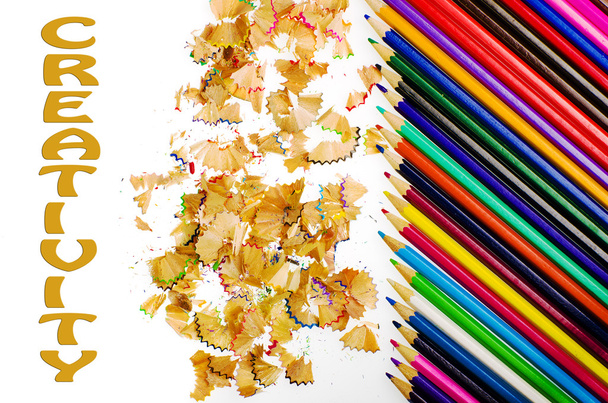Creativity written on white background, colorful sharpened pencils and shavings - Zdjęcie, obraz