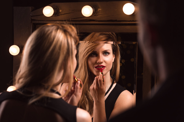 Alluring woman applying red lipstick - Zdjęcie, obraz