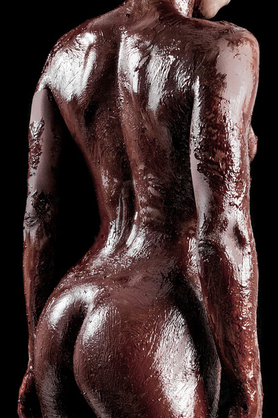 Sensual african model back portrait covered with chocolate - Foto, Imagem