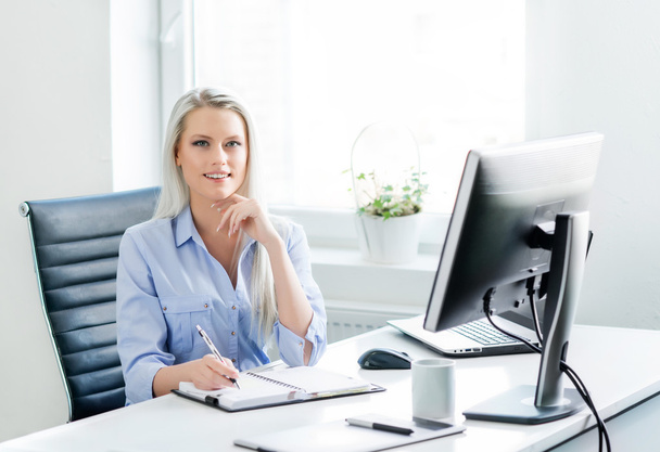 Young, attractive and confident business woman working in office - Φωτογραφία, εικόνα