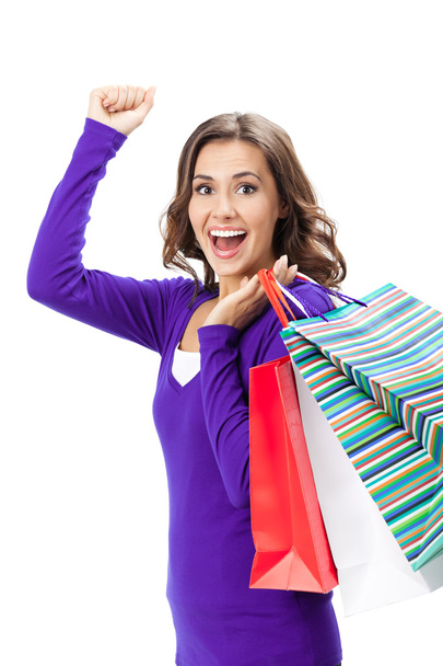 Young happy woman with shopping bags, isolated - Foto, afbeelding
