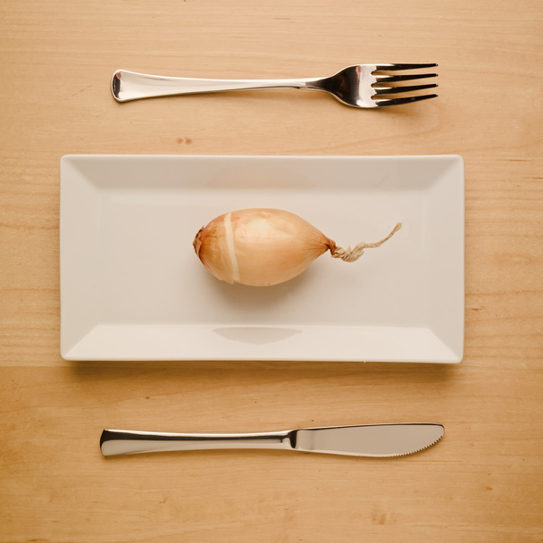 Веганська низьковуглецева дієта сира цибуля на прямокутній тарілці
 - Фото, зображення