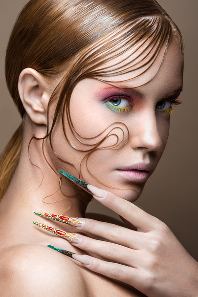 Beautiful girl with bright fashion make-up, creative hairstyle, long nails. Design manicure. Beauty face. - Foto, imagen