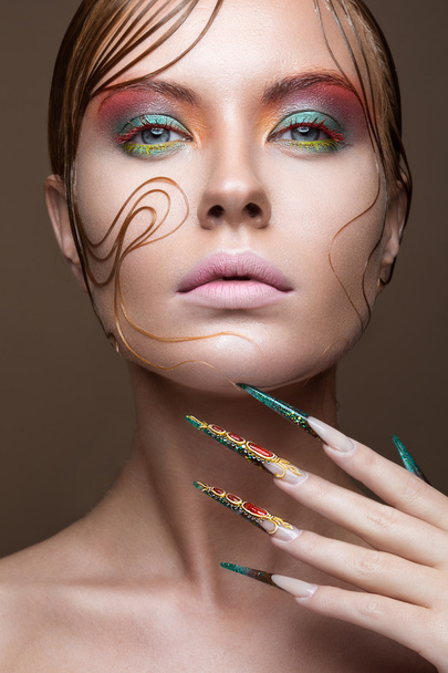 Beautiful girl with bright fashion make-up, creative hairstyle, long nails. Design manicure. Beauty face. - Foto, Bild