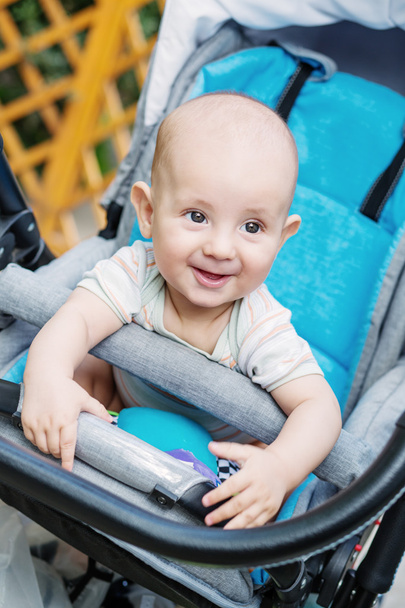 happy baby boy sitting in a stroller - Photo, Image