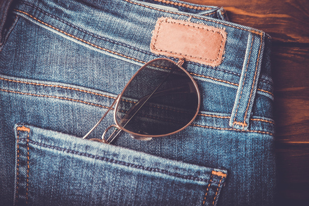 sunglasses on jean pants retro vintage style - Photo, Image
