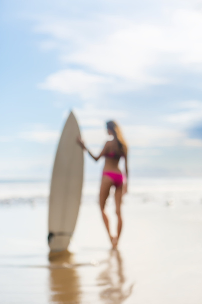 beautiful girl with long hair on the beach with surfboard - Fotó, kép