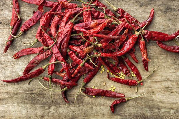 Dried red chili pepper on wooden background - Valokuva, kuva