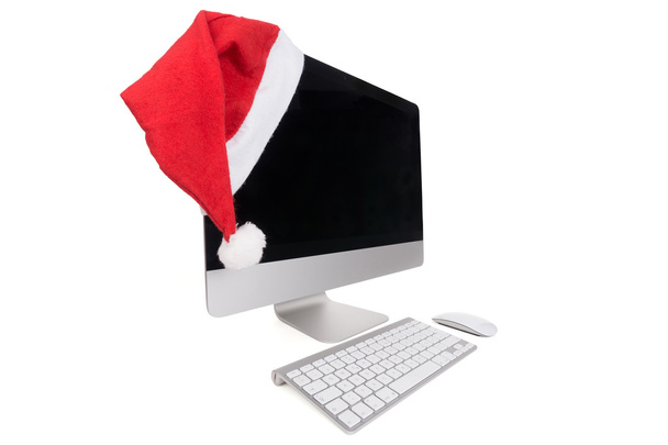 Czerwony kapelusz santa na nowoczesny Monitor komputera - Zdjęcie, obraz