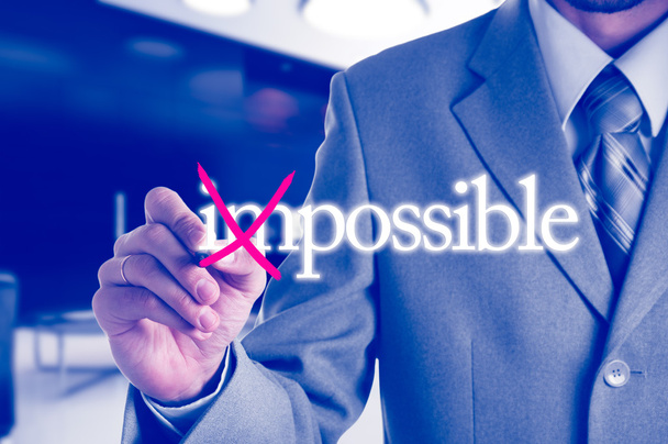 Businessman Hand turning the word Impossible into Possible with red marker - Fotó, kép