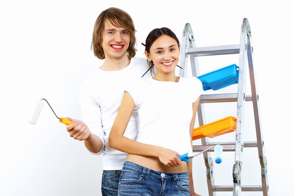 Young couple with paint brushes together - Foto, afbeelding