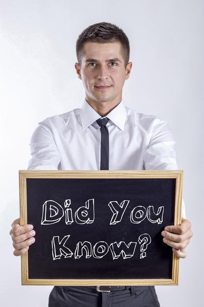 Did You Know? - Young businessman holding chalkboard with text - Foto, Imagem