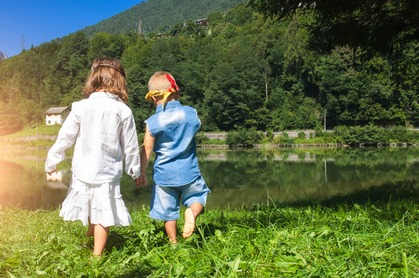children holding hands walking to the lake - Valokuva, kuva