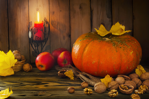 Halloween - pumpkin, nuts, apples with candlelight - Фото, изображение