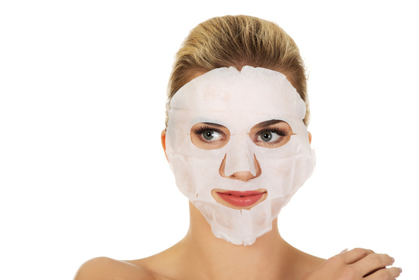 Young happy woman with facial mask. - 写真・画像