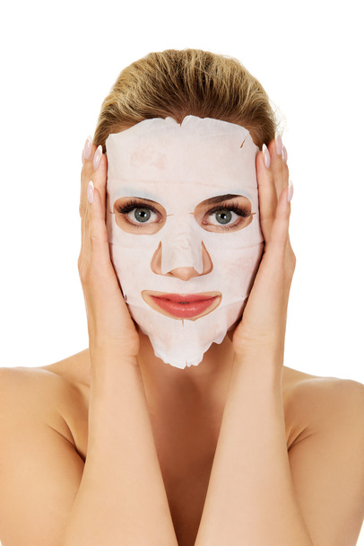Young woman with facial mask - Foto, Bild