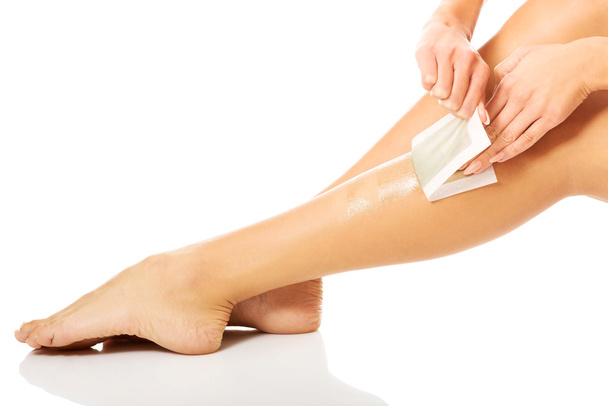 Woman waxing her leg - Fotó, kép
