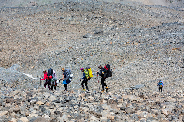 Group of people walking on rocky trail - Valokuva, kuva